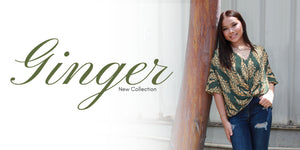 Woman in a green patterned top leaning against a wooden post with 'Ginger New Collection' text.