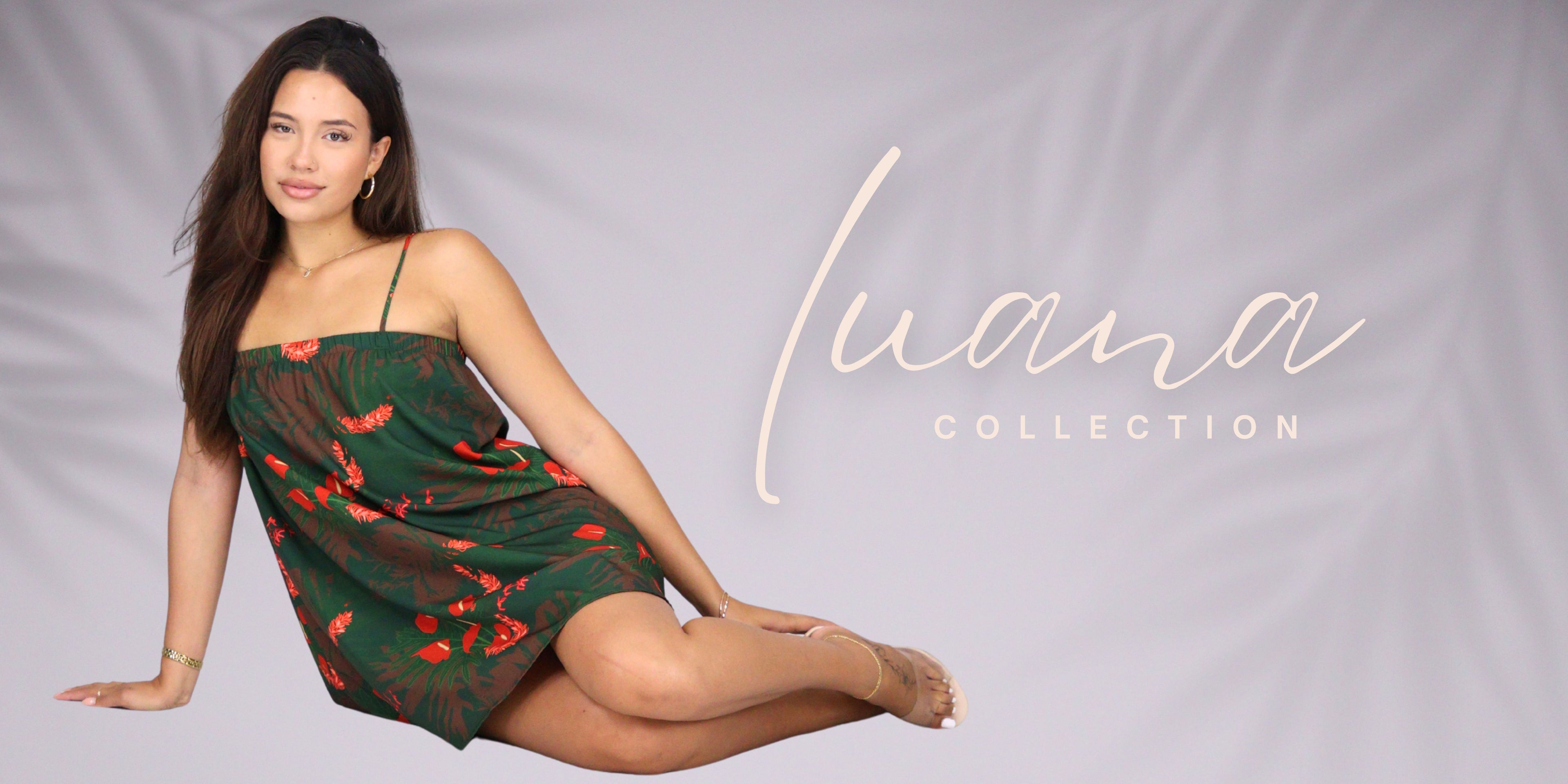 A woman models a green strapless mini dress with a red and orange floral pattern against a light gray backdrop. The text 'Luana COLLECTION' is displayed on the right side of the image.