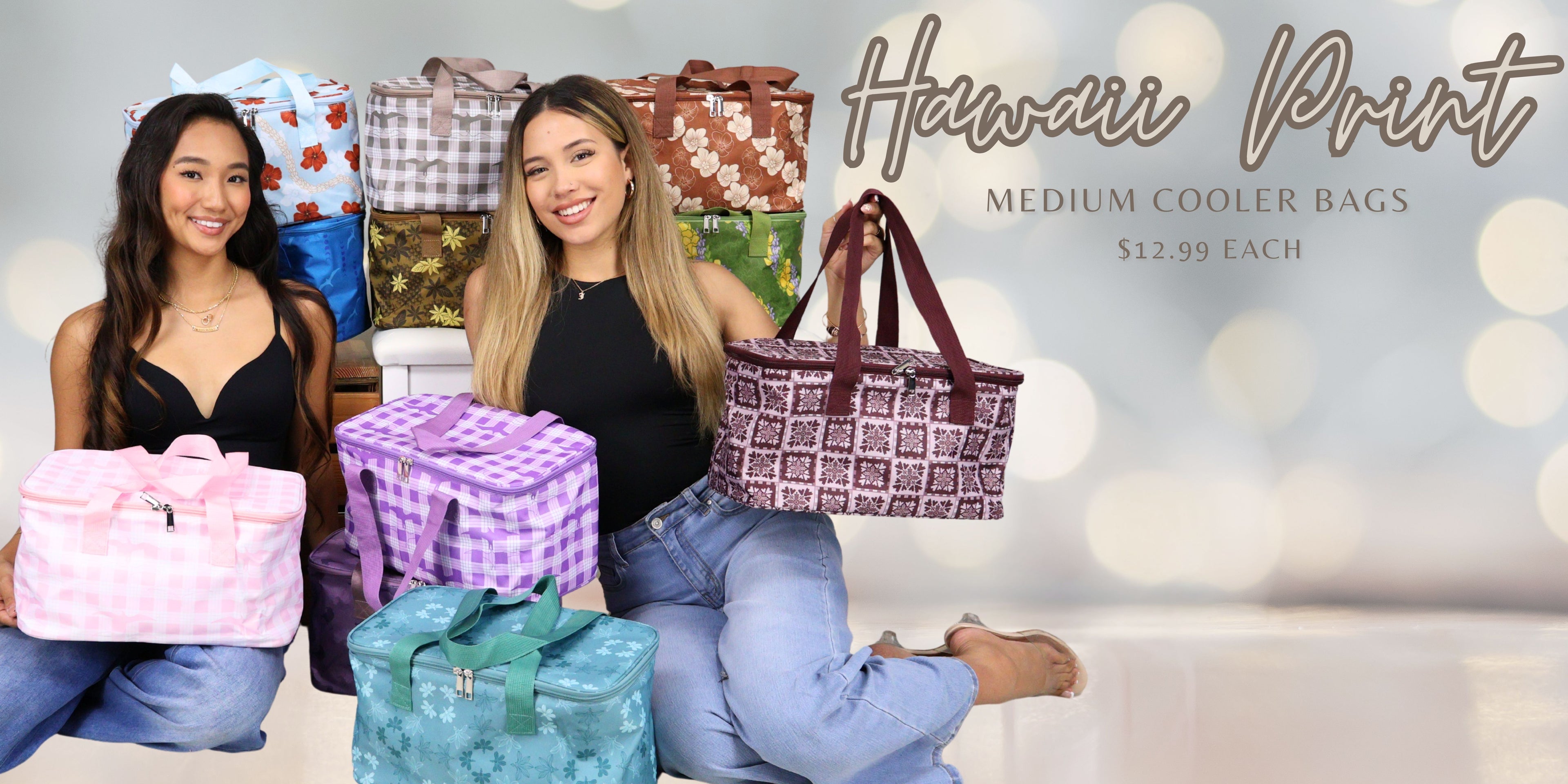 Two women sitting on a couch with various patterned medium size cooler bags displayed for $12.99 each