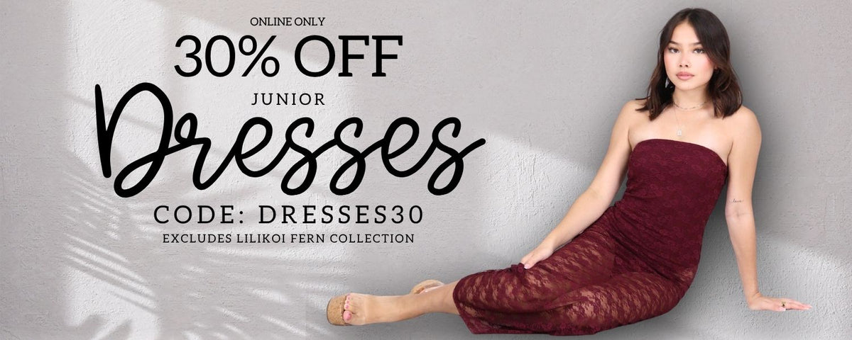 A promotional banner for online-only junior dresses, featuring a woman wearing a strapless burgundy lace dress sitting against a light gray wall. Large text on the left reads '30% OFF Junior Dresses' with a discount code 'DRESSES30' and an exclusion note for 'Lilikoi Fern Collection'.